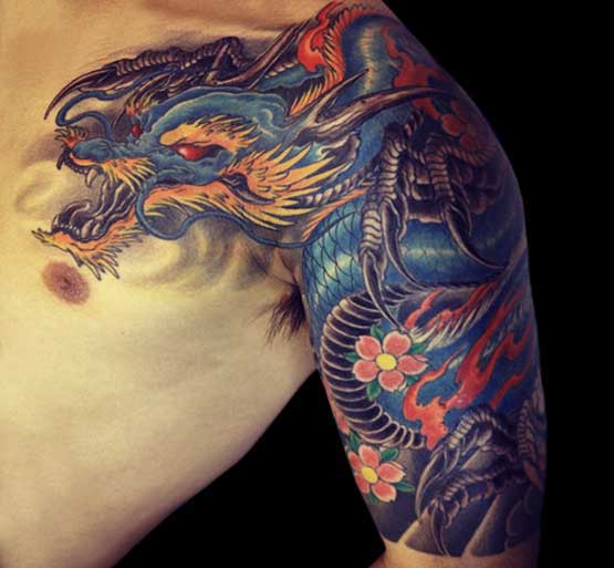 Blue Chinese dragon tattoo looks cool in the arms of a boy. When we consider is based on mythological creatures, this is a very fenomelal design in east asia.