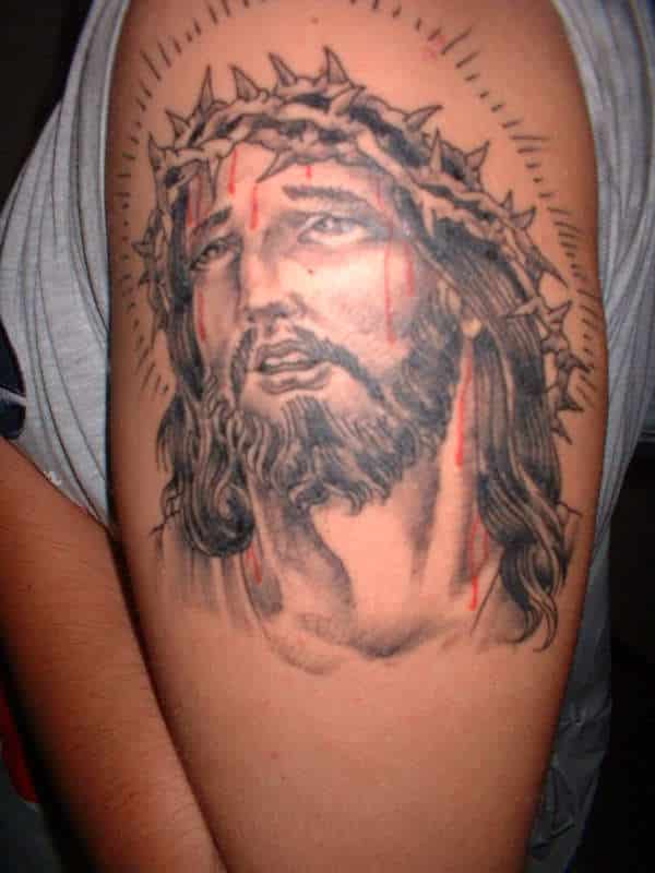 Jesus religious tattoo on biceps