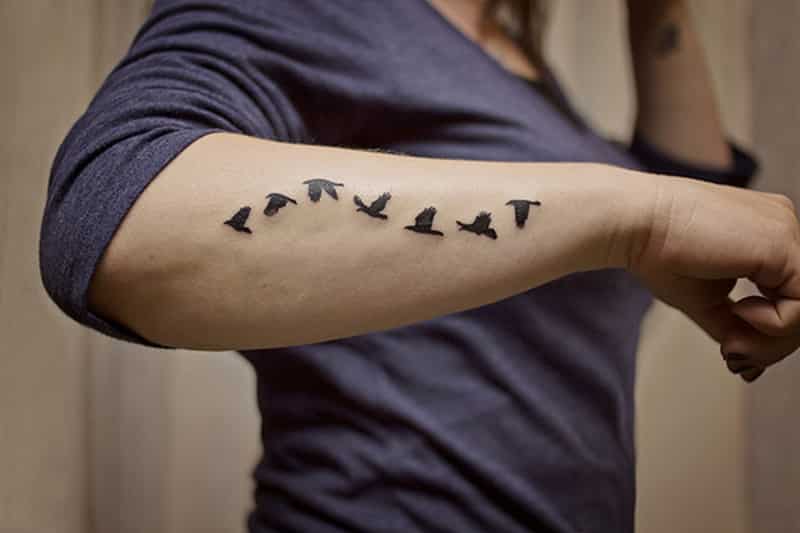 black birds tattoo on forearm